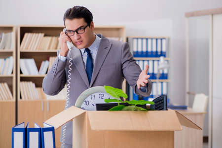 Man moving office with box and his belongingsの写真素材