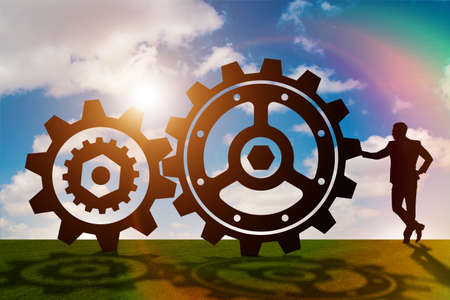 Businessman in teamwork concept with cogwheels