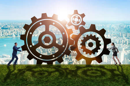 Businesspeople in teamwork example with cogwheelsの写真素材