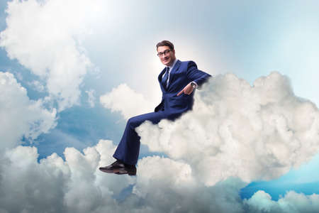 Businessman sitting on the cloud in motivitation conceptの写真素材