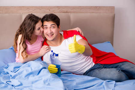 Super hero husband in bedの写真素材