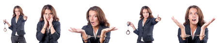 Female businesswoman with handcuffs on whiteの写真素材