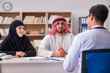 Doctor consulting arab family at hospitalの写真素材