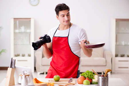 Food blogger working in the kitchenの写真素材