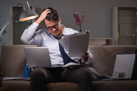 Businessman workaholic working late at home
