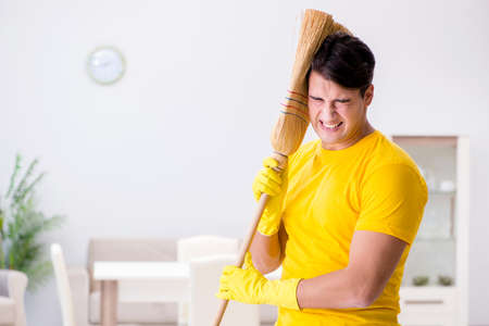 Man husband cleaning the house helping his wife