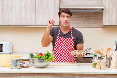 Man male cook preparing food in kitchenの写真素材