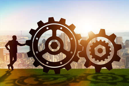Businessman in teamwork concept with cogwheelsの写真素材