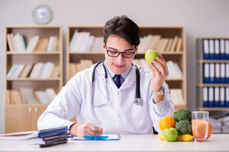 Doctor in dieting concept with fruits and vegetablesの写真素材
