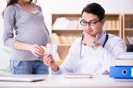 Pregnant woman visiting doctor for consultationの写真素材