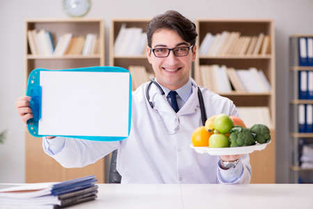 Doctor in dieting concept with fruits and vegetablesの写真素材