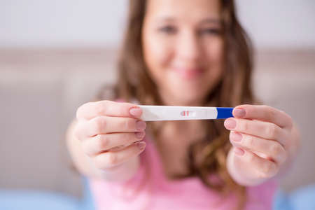 Woman discovering her positive pregnancy testの写真素材