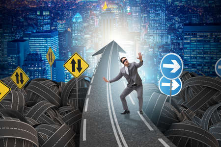 Blindfold businessman on the road unsure