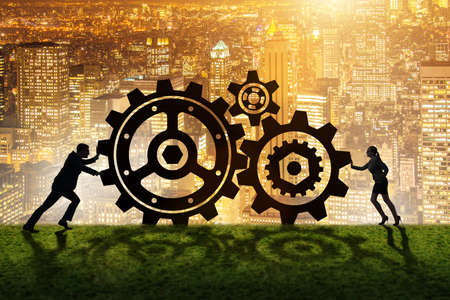 Businesspeople in teamwork example with cogwheelsの写真素材