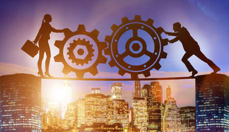 Businesspeople in teamwork example with cogwheelsの写真素材