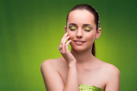 Young woman in beauty concept on green backgroundの写真素材