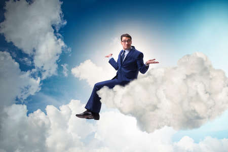 Businessman sitting on the cloud in motivitation conceptの写真素材
