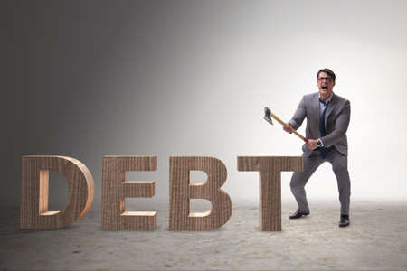 Angry man with axe axing the word debtの写真素材