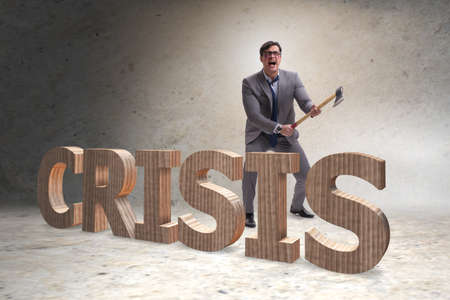 Angry man with axe axing the crisis wordの写真素材