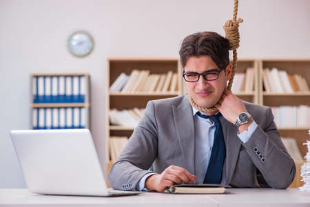 Concept of bankrupt businessman with noose around his neckの写真素材