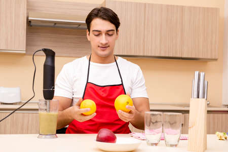Handsome man working at the kitchenの写真素材
