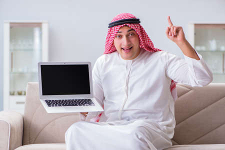 Arab businessman working sitting at couchの写真素材