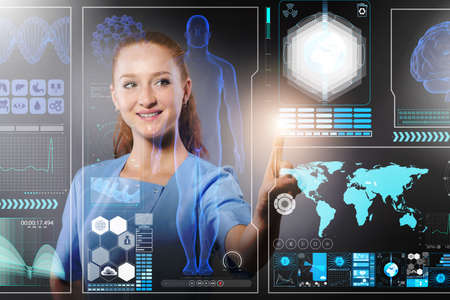 Doctor in futuristic medical concept pressing buttonの写真素材