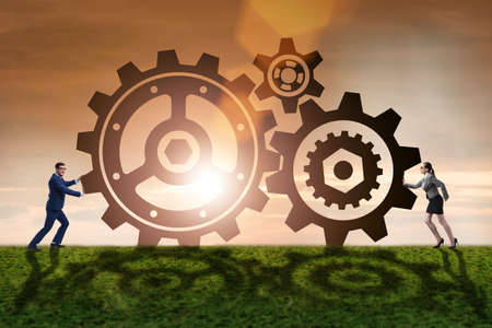 Businesspeople in teamwork example with cogwheelsの写真素材