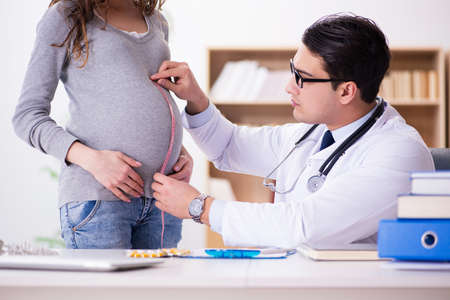Pregnant woman visiting doctor for consultationの写真素材