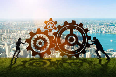 Businesspeople in teamwork example with cogwheelsの写真素材