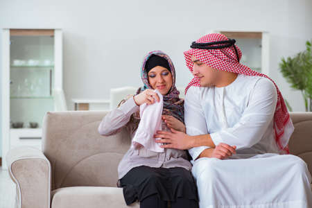 Young arab muslim family with pregnant wife expecting babyの写真素材