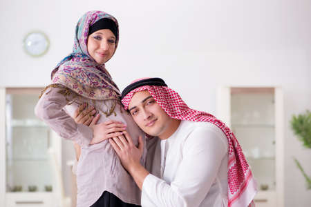 Young arab muslim family with pregnant wife expecting babyの写真素材
