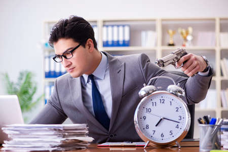 Young businessman in time management conceptの写真素材