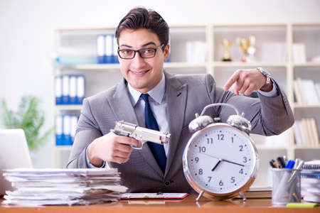 Young businessman in time management conceptの写真素材