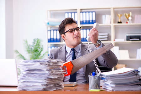 Angry aggressive businessman in the officeの写真素材