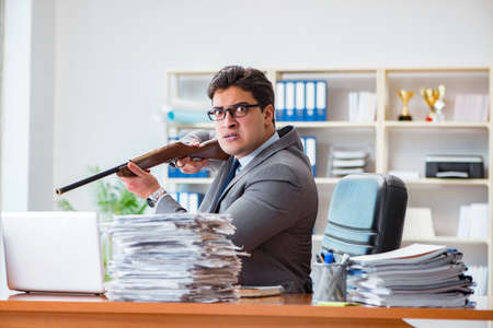 Angry aggressive businessman in the officeの写真素材