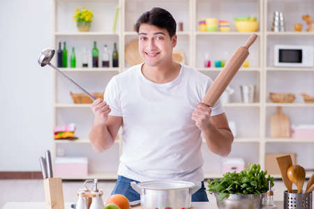 Young male cook working in the kitchenの写真素材