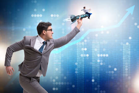 Businessman on rocket in trading conceptの写真素材