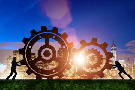 Businessman in teamwork concept with cogwheelsの写真素材