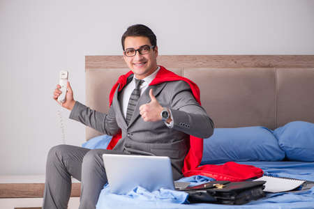 Super hero businesswoman working in bedの写真素材