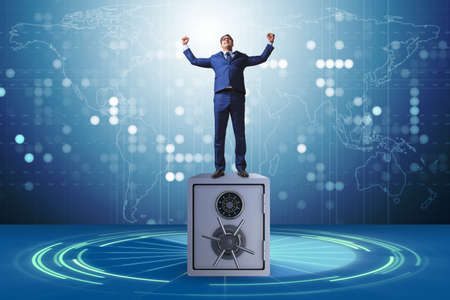 Businessman standing on top of safeの写真素材