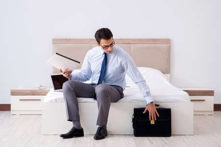 Businessman working in hotel roomの写真素材