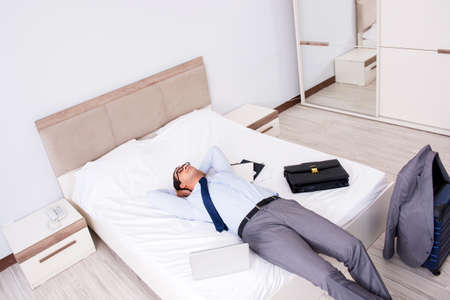 Businessman working in hotel roomの写真素材