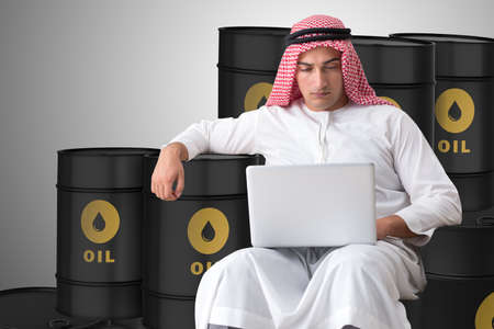 Arab businessman trading crude oil on laptopの写真素材