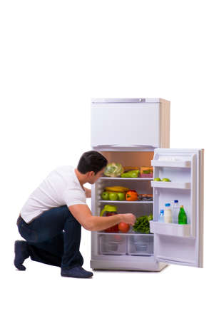 Man next to fridge full of foodの写真素材