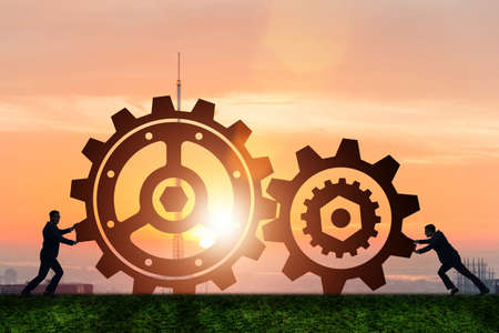 Businessman in teamwork concept with cogwheelsの写真素材