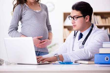 Pregnant woman visiting doctor for consultationの写真素材