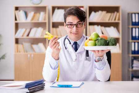 Doctor in dieting concept with fruits and vegetablesの写真素材