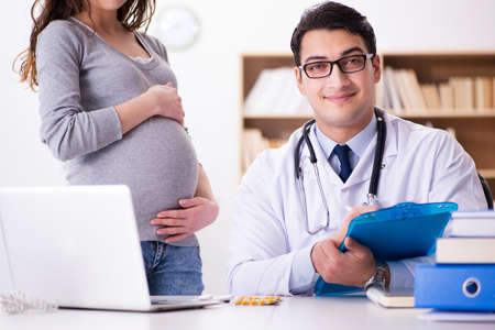 Pregnant woman visiting doctor for consultationの写真素材