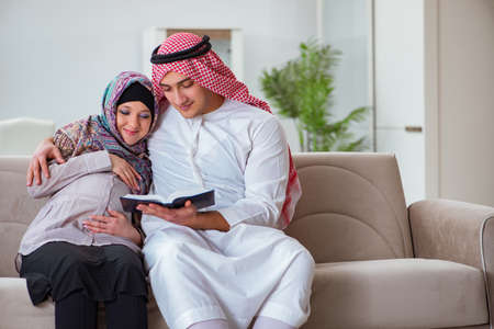 Young arab muslim family with pregnant wife expecting babyの写真素材